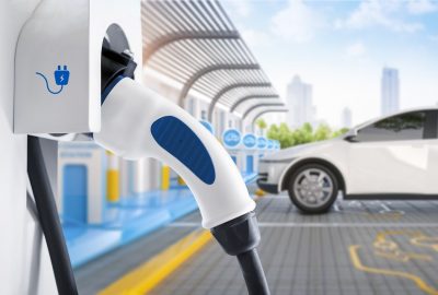 3d rendering white ev car or electric vehicle plug in with recharging station