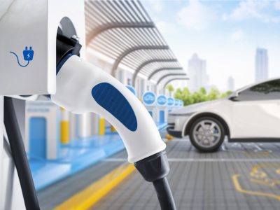 3d rendering white ev car or electric vehicle plug in with recharging station